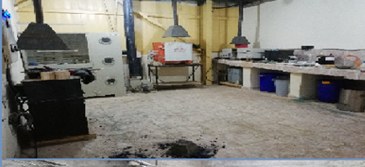 Testing laboratory with fume hoods, a small furnace, and analysis benches